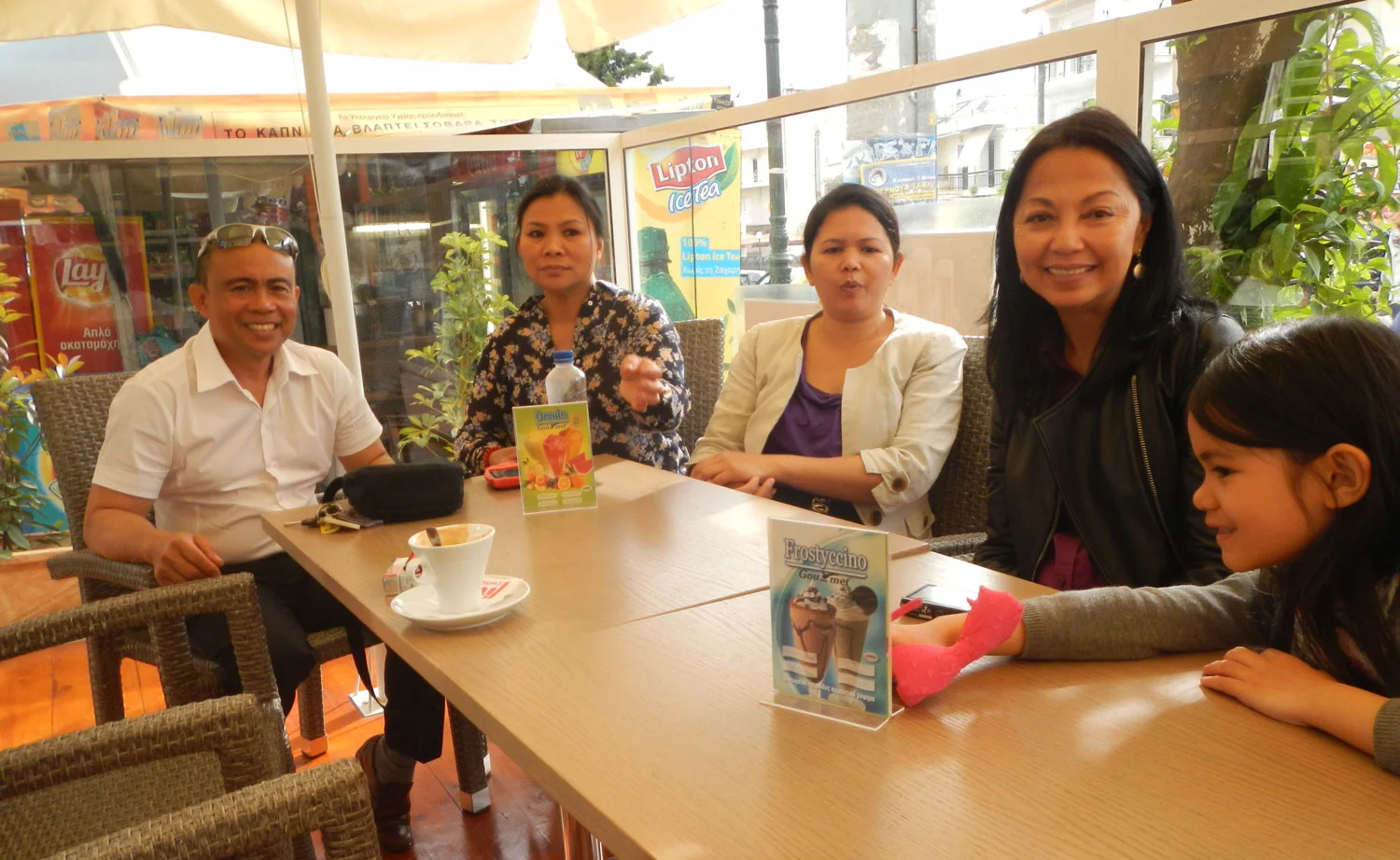 After the disappointment of not spotting a single Filipino in Istanbul, I was rewarded with&nbsp;the pleasure of meeting a very cheerful Filipina named Rowena Reyes (in the floral dress).&nbsp; She was on the wait staff at the Athens Hilton and when she showed up with a glass of orange juice, I told her of my disappointment.&nbsp;&nbsp;She told me not to fret as she would arrange for me to meet Filipinos.&nbsp; Sure enough, she sent&nbsp;Edward and Rosemarie Rifareal to take us to a Filipino gathering at their&nbsp;church.&nbsp; It turned out that the church, which was attended mostly by&nbsp; kababayans , was celebrating its fifth anniversary.&nbsp; We were treated to Filipino food which we were&nbsp; starting to miss.&nbsp;The charming little miss is Edward's and Rosemarie's daughter Precious.&nbsp; (Photo by Albert Romero)