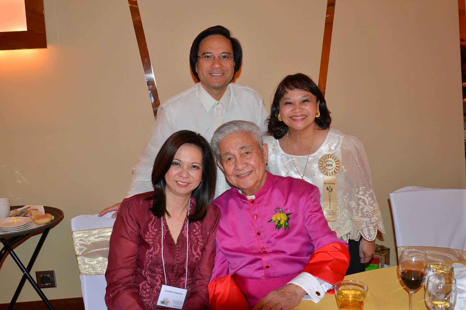 The author with Monsignor Fred Al Bitanga on his 50th Anniversary of his Ordination to Priesthood, April 26, 2014. With Tony and Bernadette Sy (Photo courtesy of Lourdes Santos Tancinco)
