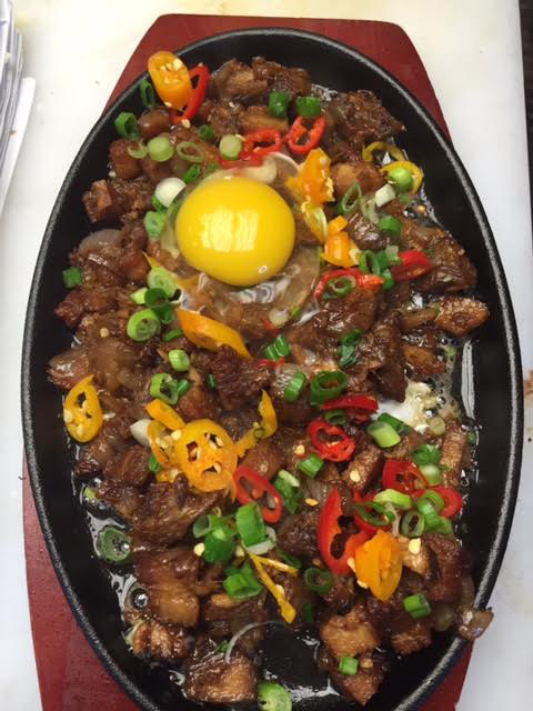Purple Patch D.C. offers a spicy, sizzling Pork Sisig appetizer, a customer favorite. (Photo courtesy of Purple Patch D.C.)