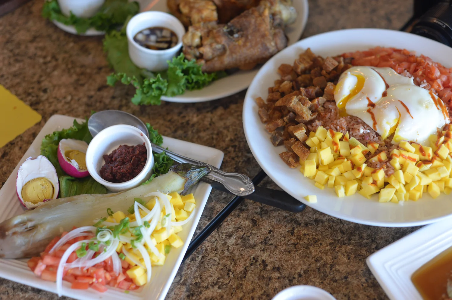 Hinamburang Talong and Bagoong Rice Medley (and Crispy Pata in the background). Dishes are served family-style. (Photo by Sunantha Mendoza-Quibilan)