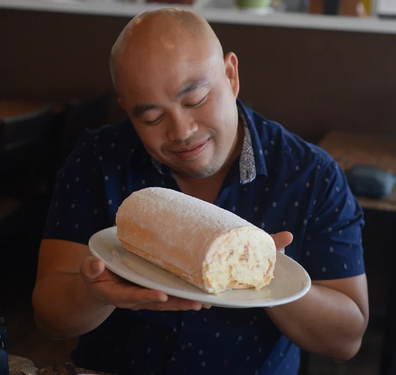Joey Ngoy (@jofieats) cradles a roll of Frozen Mango Brazo. (Photo by Sunantha Mendoza-Quibilan)