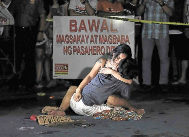 The "La-Pieta" like photo which symbolized the extra judicial killings in the Philippines (Photo by Raffy Lerma/Philippine Daily Inquirer)