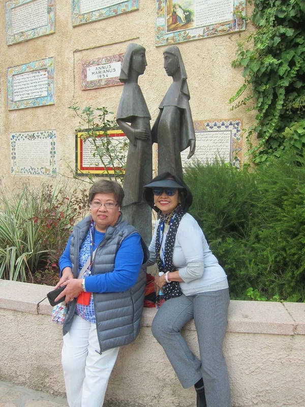 Sculpture of Mary and Elizabeth with pilgrims Beth Milena (left) and Binky Camara