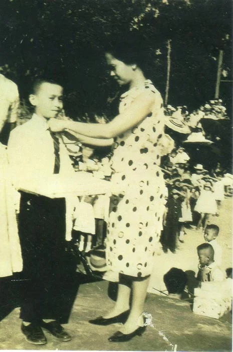 The author's mother pinned him a ribbon at his school's closing ceremonies on April 17, 1964. (Photo courtesy of Rey E. de la Cruz)