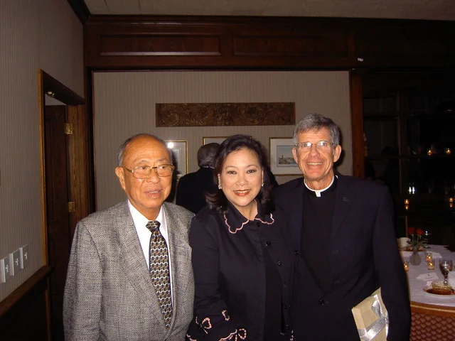 Dinner after the conferment of an honorary degree in 2005. With Fr. Steve Privett, S.J., president of USF.