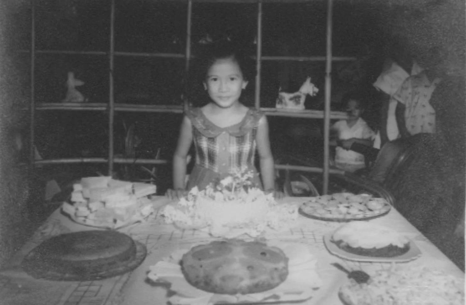 Author at her 6th birthday party with vault behind the bamboo shelving (Photo courtesy of Lilia V. Villanueva)