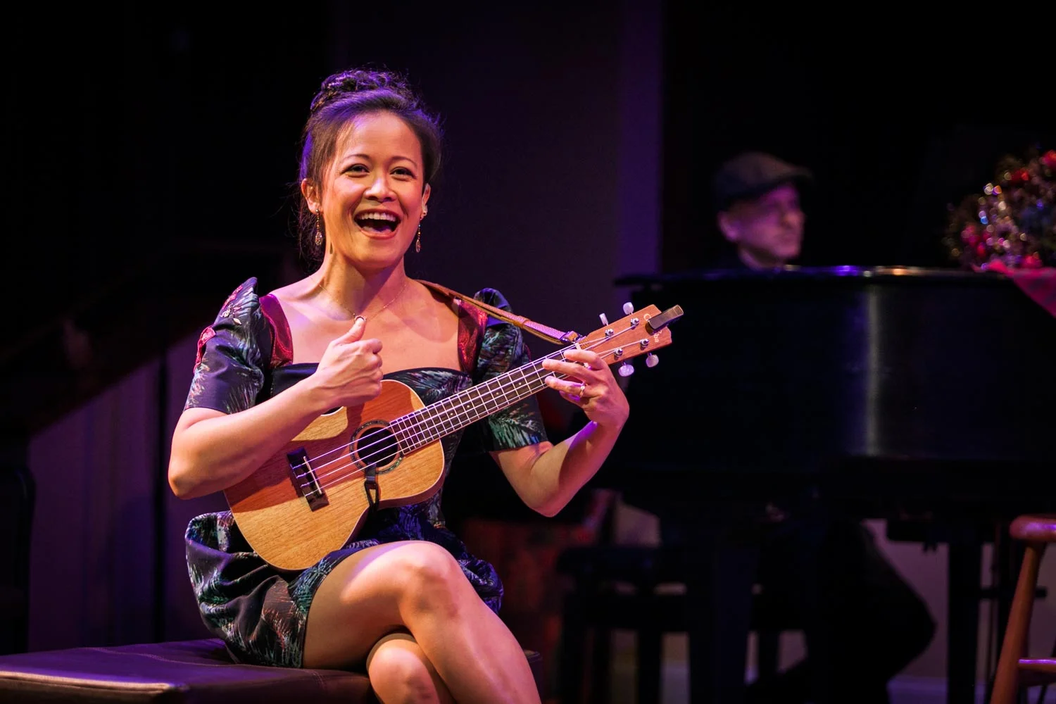 Bunuan playing her ukelele in "Christmas at Christine's" (Photo courtesy of Silk Road Rising, Photo by Susie Inverso of Crimson Cat Studios)