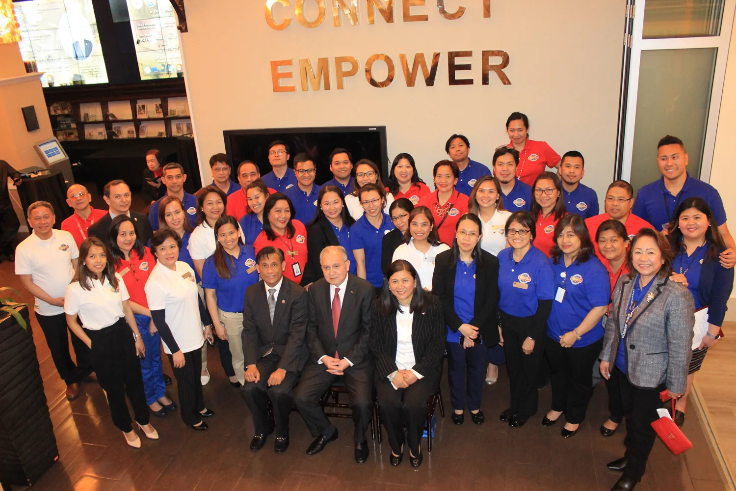 Philippine Consulate staff greet Ambassador Jose Manuel Romualdez on his visit.