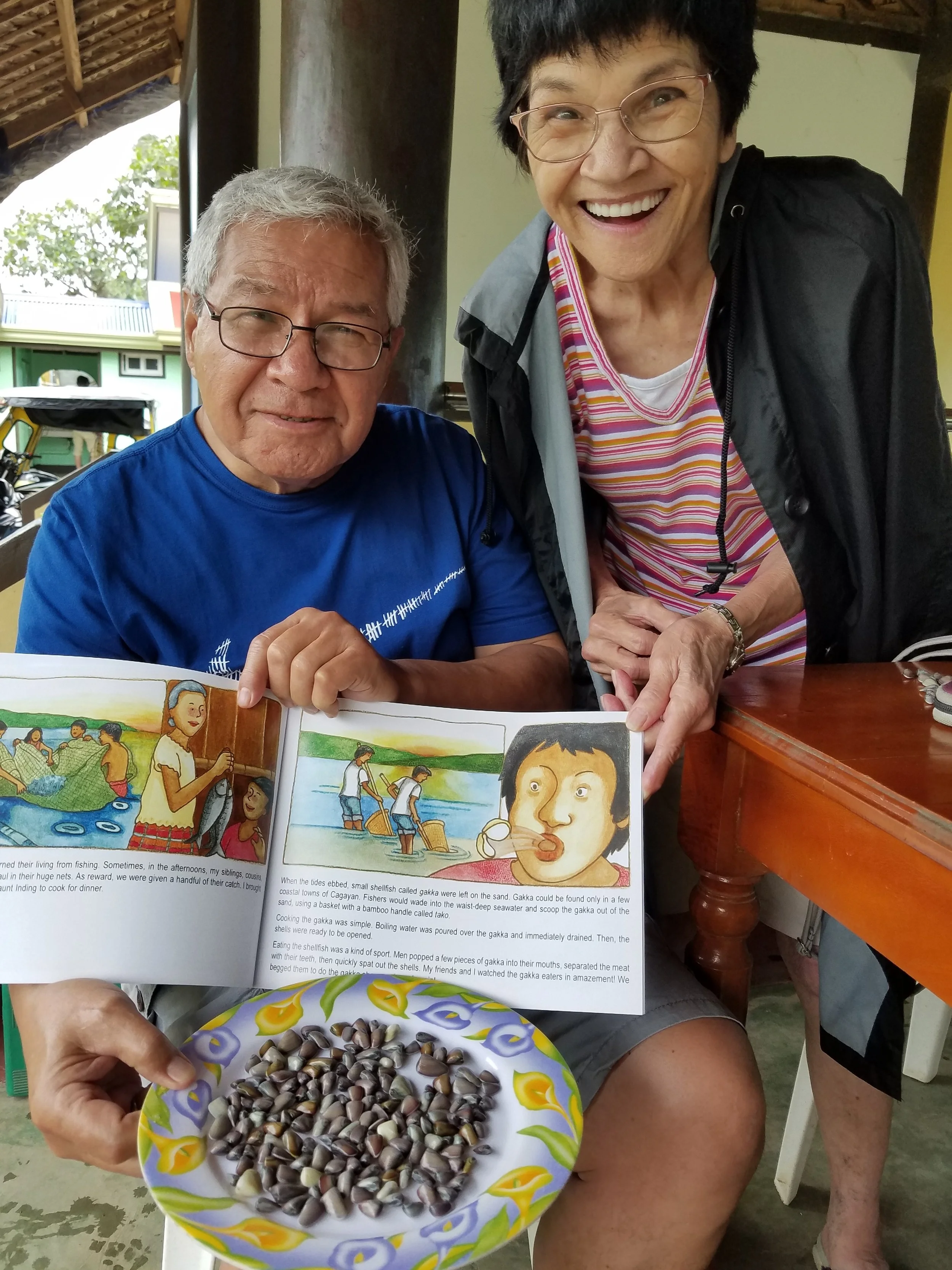 My dad and Aunt Rose are delighted with the shellfish gakka, which is immortalized in the book, Ballesteros on My Mind: My Hometown in the Philippines. (Photo courtesy of David R. Rabaja)