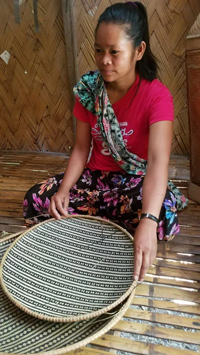 Kamantian villager with her bamboo trays. (Photo by Jill Stanton)