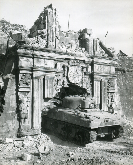 An American tank rumbles through the historic gate of Fort Santiago inside the Walled City on February 26, 1945. (National Archives)