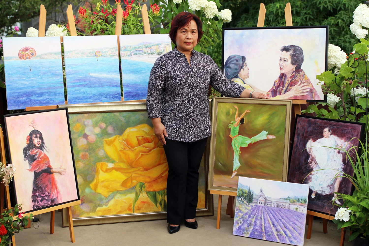 Esmie Gayo McLaren and her paintings (Photo courtesy of Esmie Gayo McLaren)