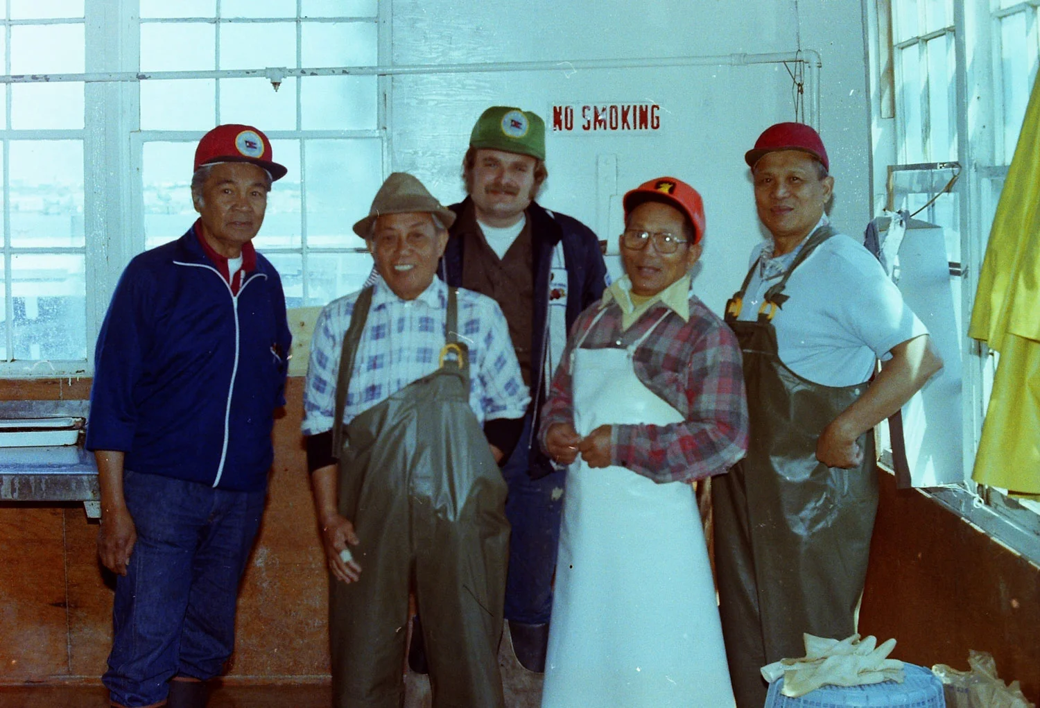 Filipino cannery workers posting with Steve Gillon (back), a machinist. (Photo by Tom Connelly, 1979)