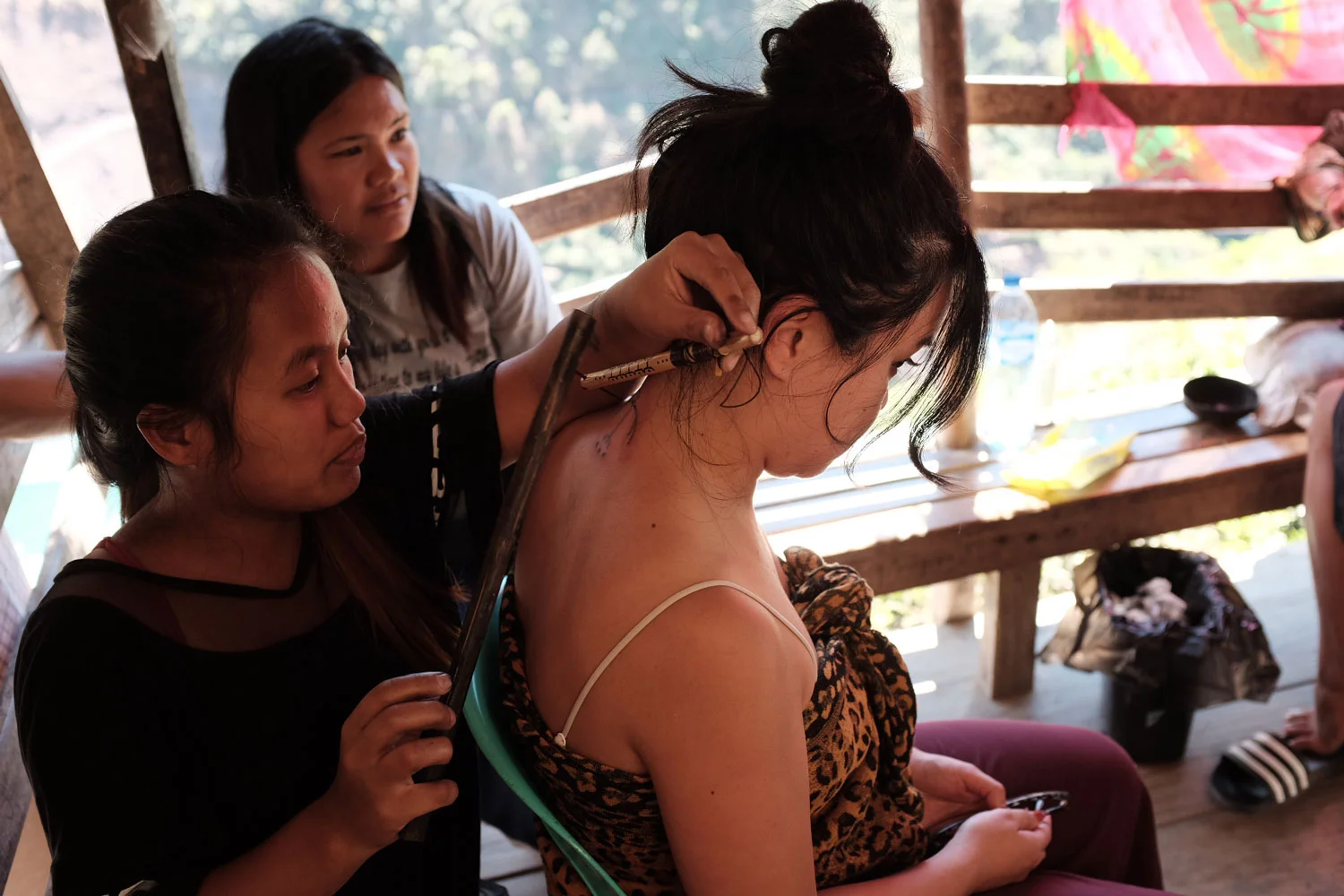 With no direct descendants, Whang Od is training her grandniece to carry on the mambabatok practices. Grace and Elyang are her primary apprentices. Elyang, pictured here, completed my standing eagle tattoo (Photo by Jensen Esteves).
