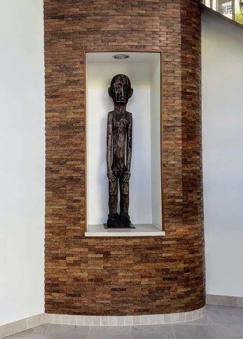 A bulul sits prominently in the first floor level, facing the street. From the Richard Gervais Collection.
