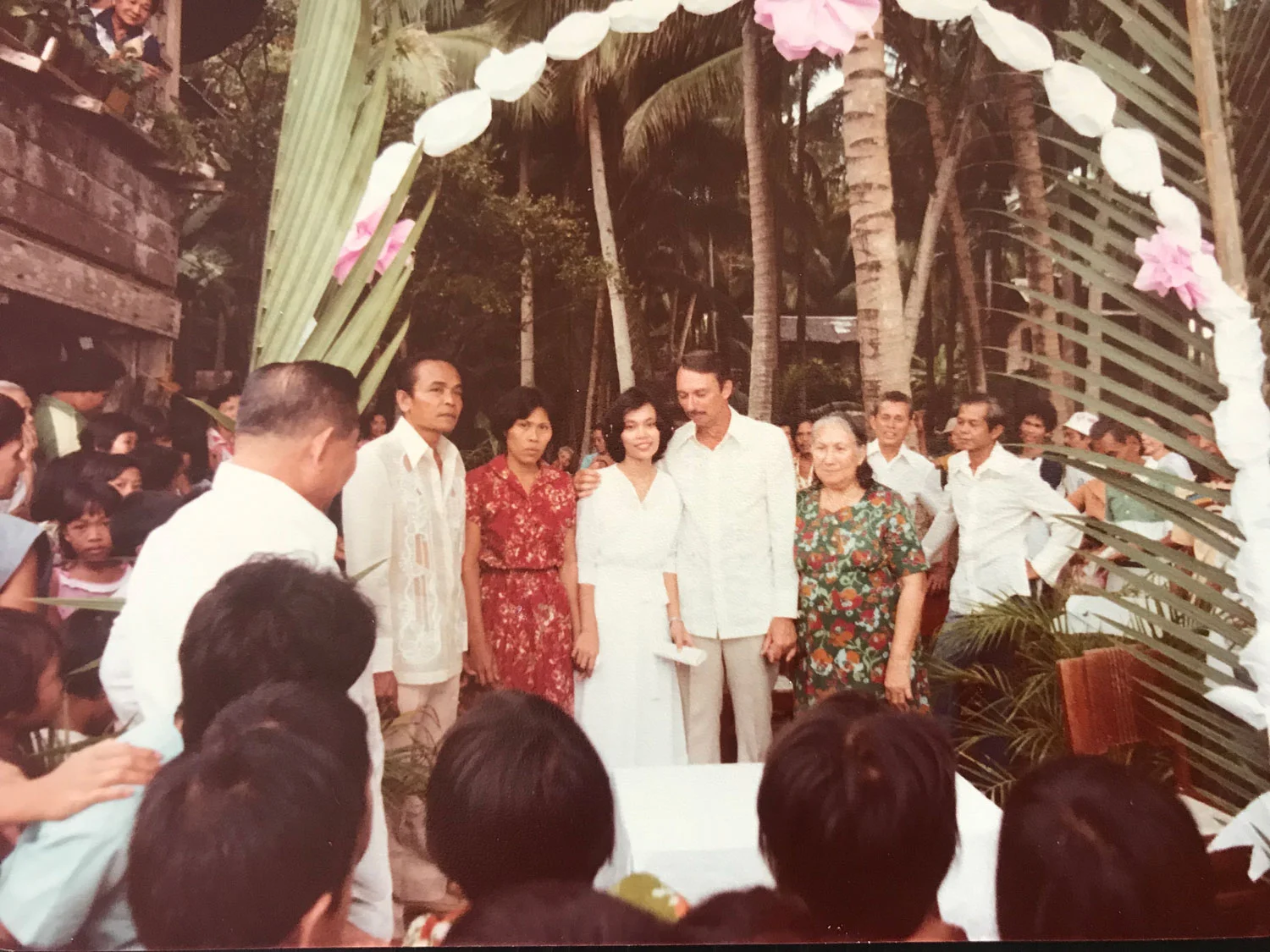 As a divorcee, my dad could not be married in the Catholic Church. Here, they stand center at their wedding ceremony in the front yard of my childhood home. My mom holds my Grandma Inega's hand.