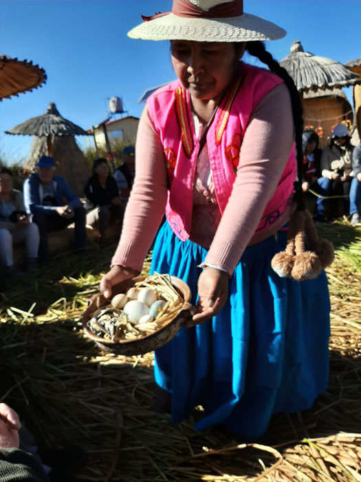 A woman of an Uros floating island in Lake Titicaca shows off different eggs they gather on their island (Photo by Bella Bonner)