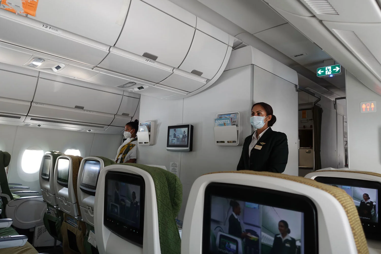Ethiopian Airlines flight crew greet passengers with masks on.