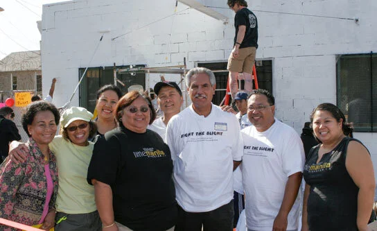 Little Manila's "Fight the Blight" campaign in 2005. Dr. Dawn Mabalon (right) with Dillon Delvo with Stockton Mayor Ed Chavez (middle, white shirt). Dr. Mabalon and Delvo founded Little Manila to preserve the Filipino American community. Front, L-R: Vergie Navarro, Debbie Louie, Mayor Ed Chavez, Dillon Delvo, Dr. Dawn Mabalon. Back: Elena Buensalido Mangahas and Antonio Somera. The building being cleaned and painted is the Iloilo Circle in the Little Manila historical district. (Photo by James Sobredo)