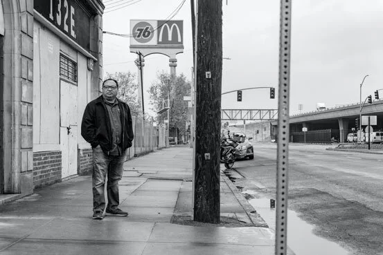 Dillon Delvo, co-founder &amp; executive director of Little Manila Rising, in downtown Stockton, the location of historic Little Manila. Behind him are the Interstate 5 freeway and the Port of Stockton. (Photo by James Sobredo)
