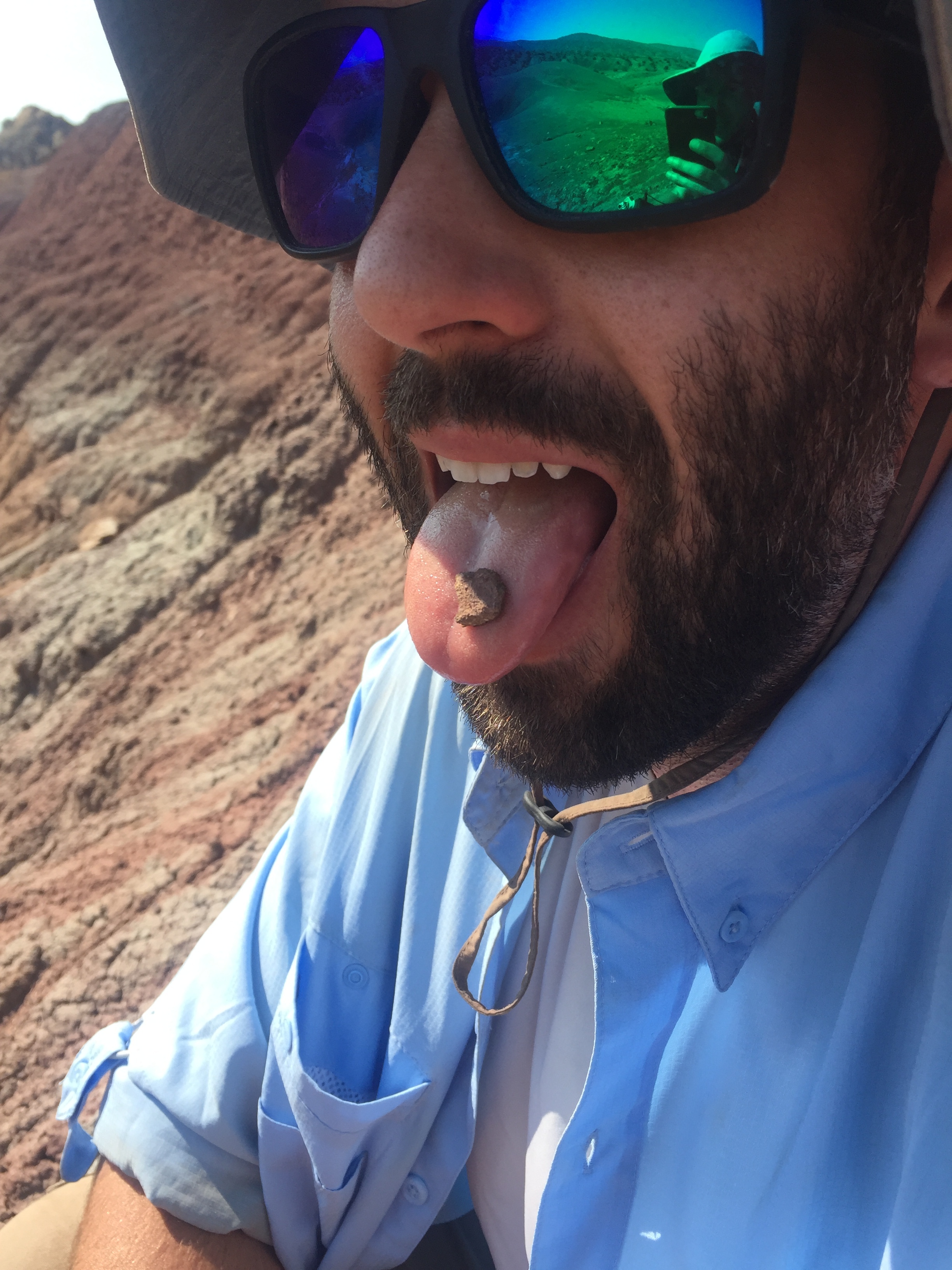 Dr. Mike D’Emic demonstrates "the lick test” to determine if we’ve found a fossilized bone or a rock.