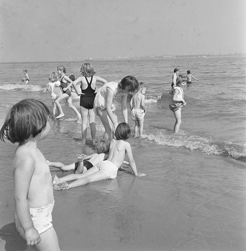 Children playing in the sea at New Brighton “We’d all be sitting on the sand and we’d go in the water, but not too far out, just a paddle.” Betty Jamieson, Kensington Fields Community Association