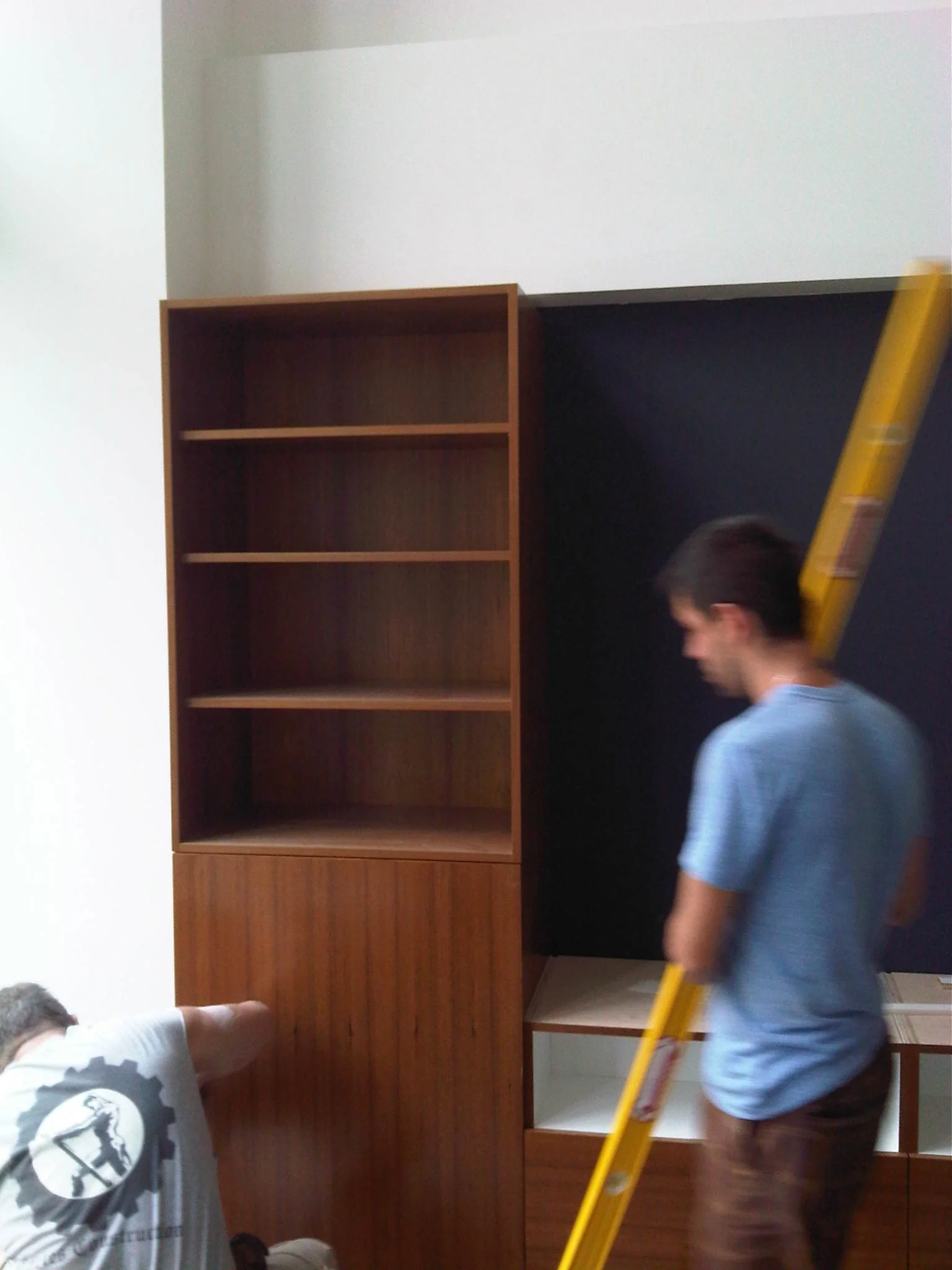 Living Room millwork install tall cabinet.jpg