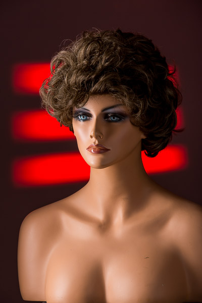 Adding a projection to the background created by a speedlight, a cardboard gobo, and a red gel