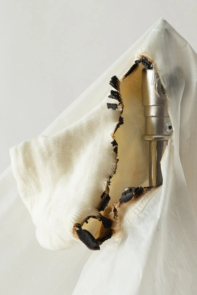 The elastic sock slipped forward and came into contact with the glass diffusion dome on a strobe head with a hot 250-watt quartz halogen modeling lamp