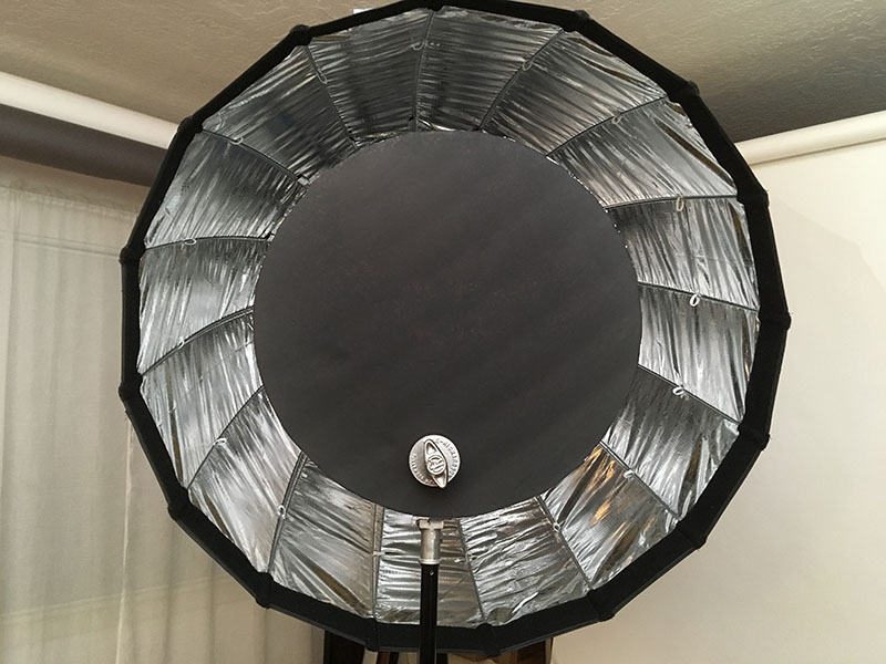 Black foam-core disk blocking the center of the deep parabolic softbox