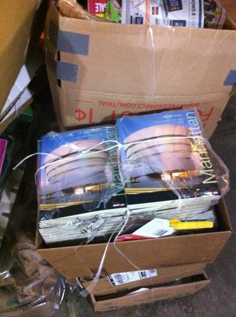 Stack of phone directories sitting in a pile of trash on my street