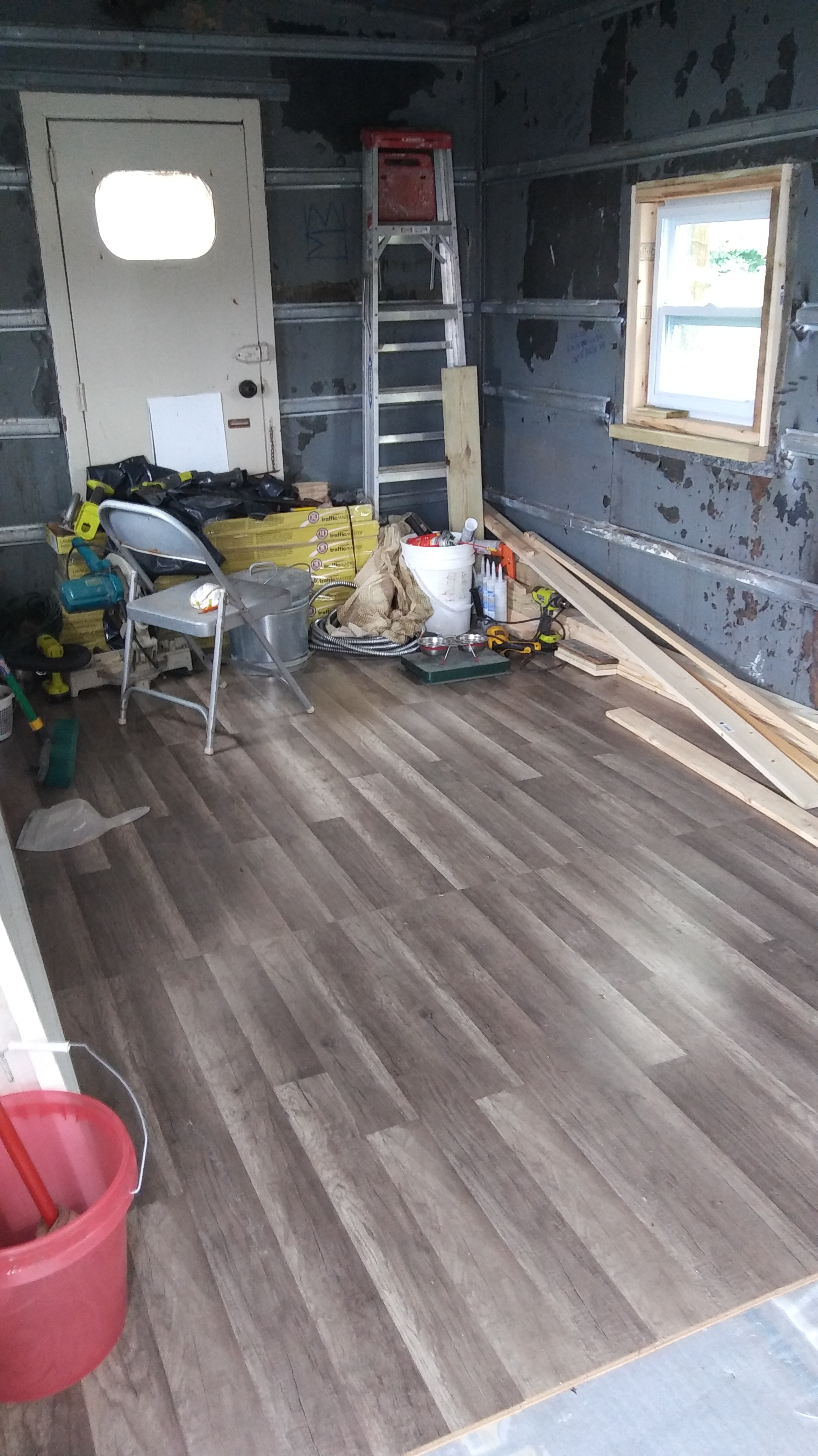 Our new floor - Don't get us wrong. We loved the original pine floor, but we didn't have the time or resources to properly restore it. The floor had many holes, patches, and rotten bits, but the good bits were lovely! The original floor lives under this one for a future day when someone has the time and resources to bring it back to life.