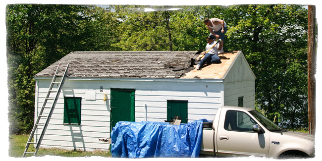 Volunteers replace the roof on Cabin 9.