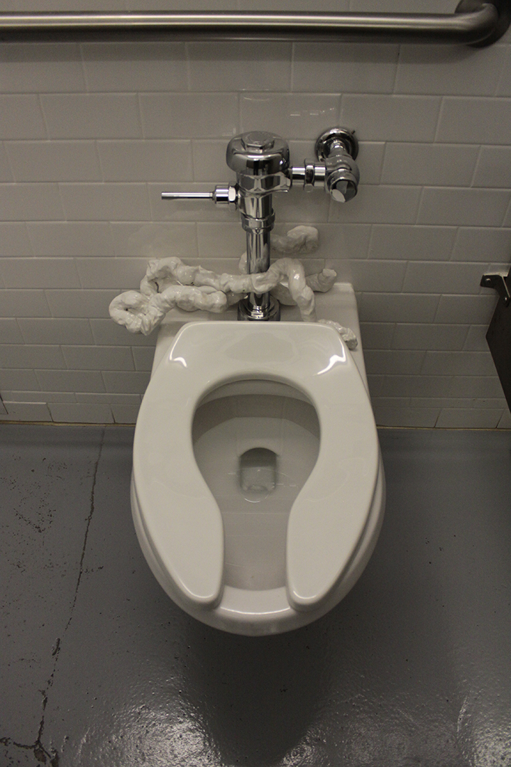   Porcelain intestines , 2013, porcelain mounted on restroom sink as part of “In Loo” exhibition, 5” x 12” x 6” 