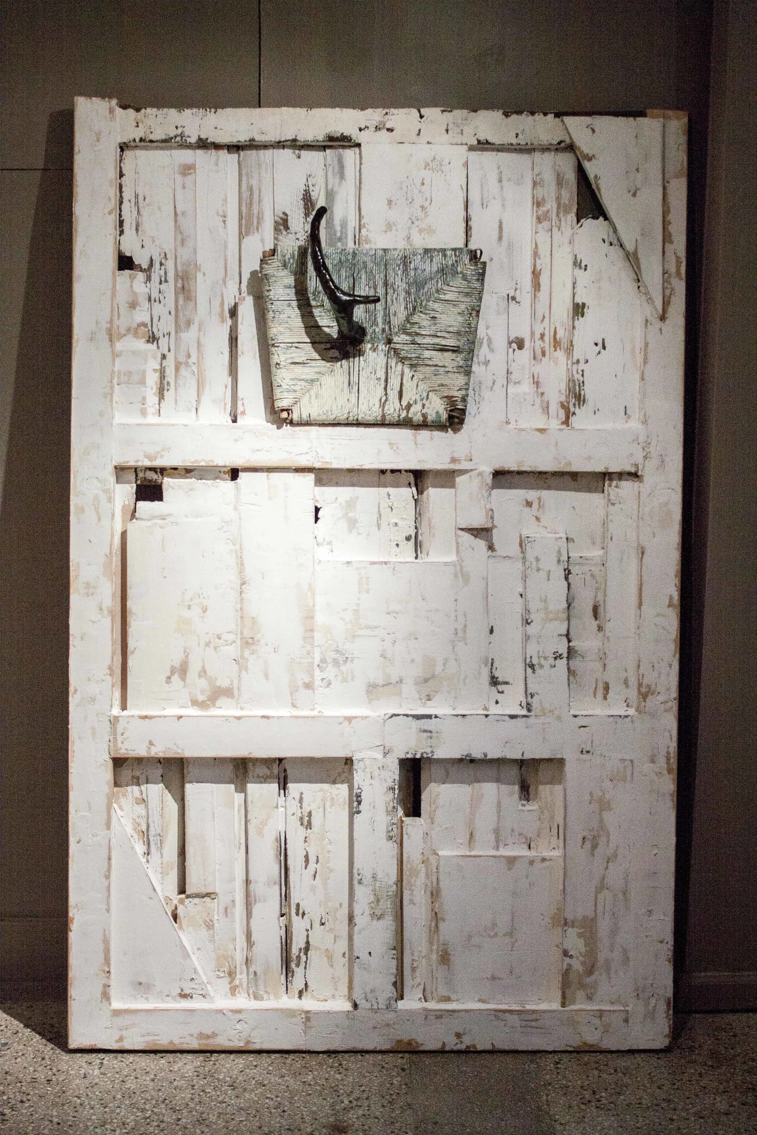 Grit, 2014, wood, glue, wood filler, spackle, wicker, paper, tar, 75" x 48 1/2" x 10"