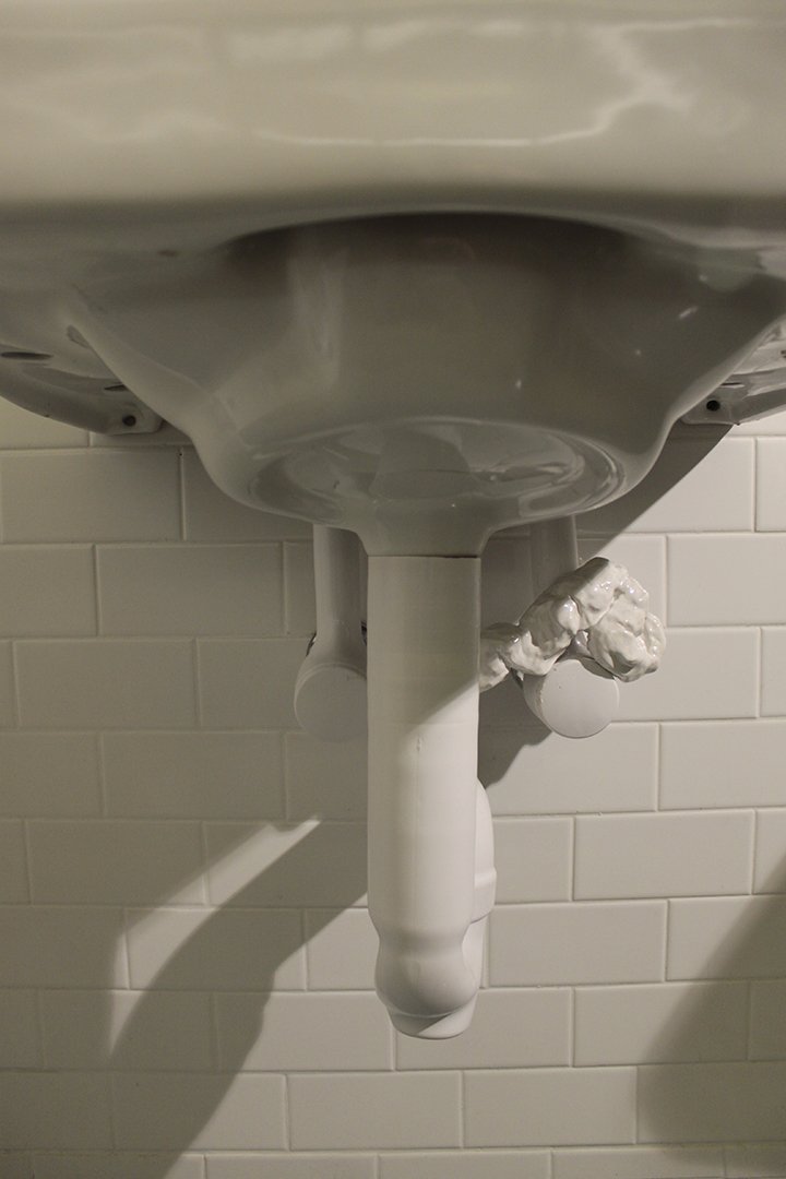   Porcelain intestines , 2013, porcelain mounted on restroom sink as part of “In Loo” exhibition, 9” x 6” x 5” 