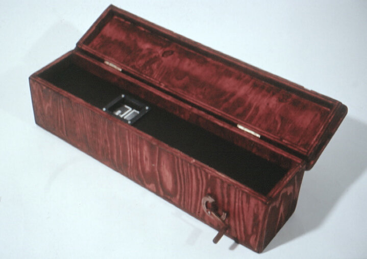Inspired by 19th Century peep shows, you crank the handle to move the black and white photographs past the window.