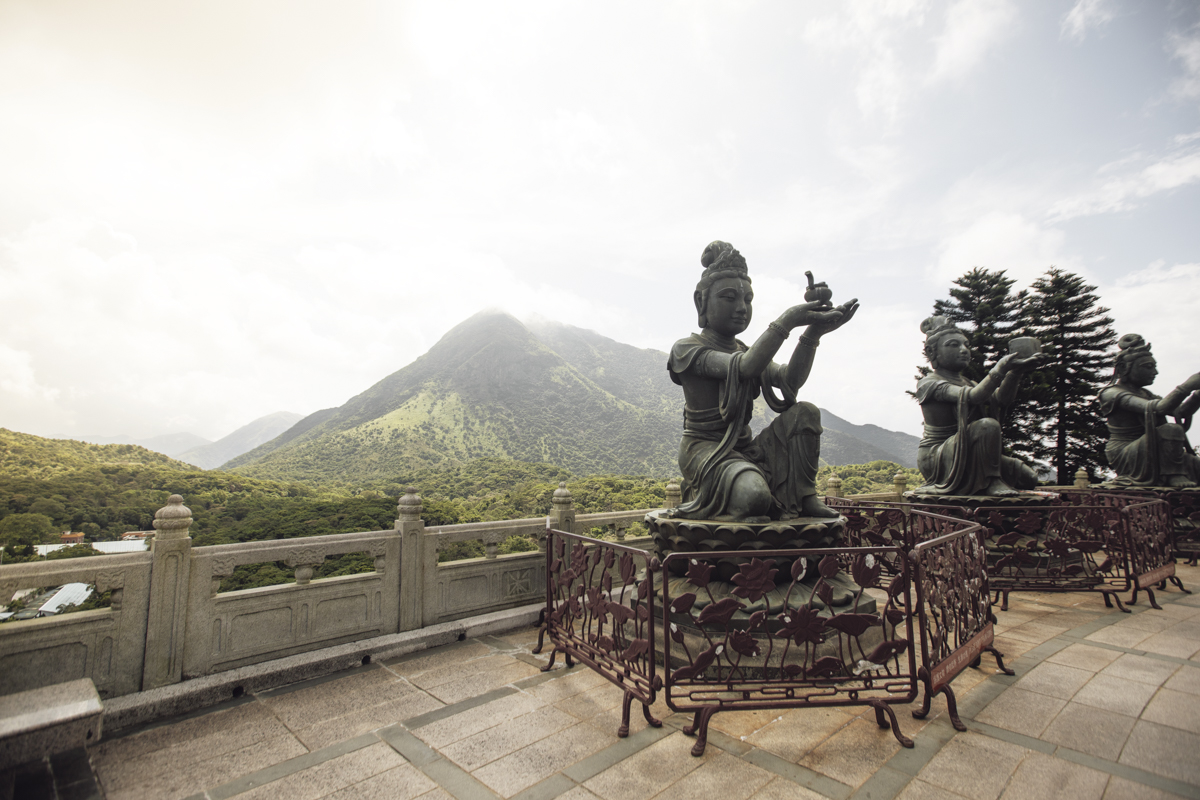 One of the 6 buddhistic statues praising and making offerings to the Tian Tan Buddha .