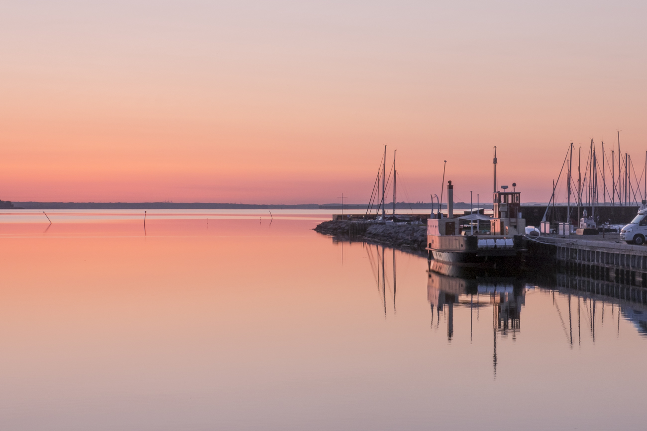 As night falls, the sky in the harbour starts showing it's many colors.