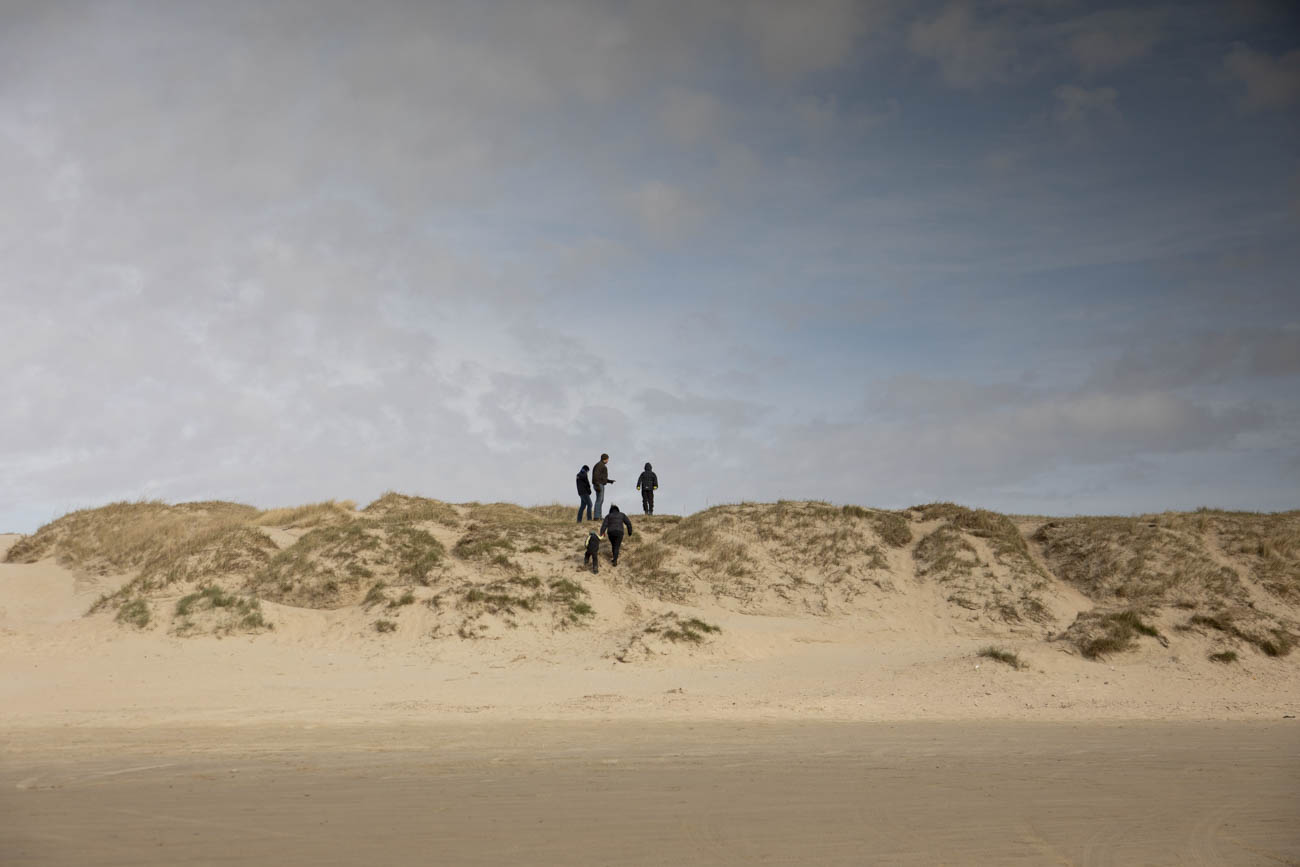 Families that are enjoying the natural playgrounds on the beach.
