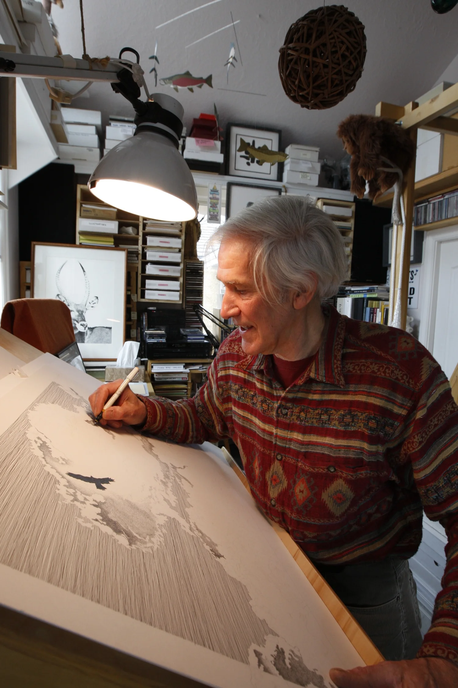 Fred Montague stipples cloud details on "Feathers that Touch the Clouds". Photo by Tom Smart.