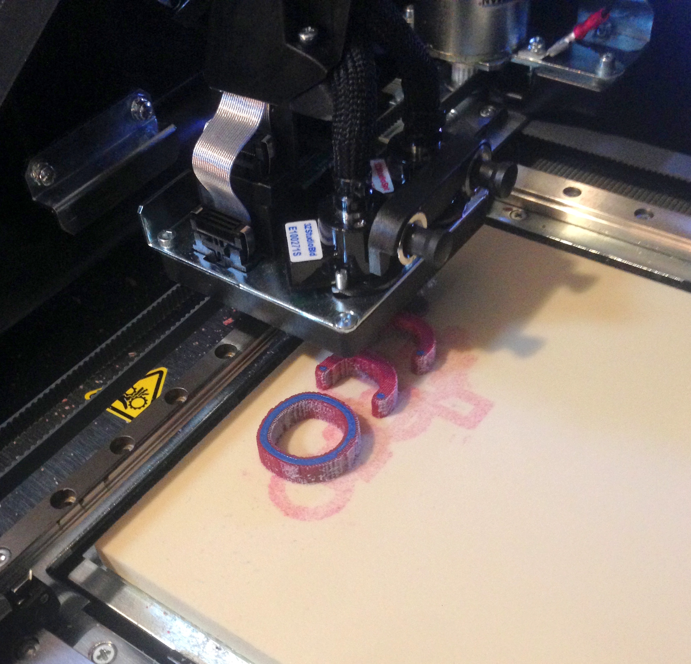 Two halves of Sarah's ring and Adam's band printing on 3-d printer