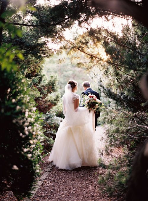 Lily and Jeff explore the gardens at Cheekwood Botanical Gardens moments after becoming husband and wife. Wedding planning and design by Big Events Wedding.