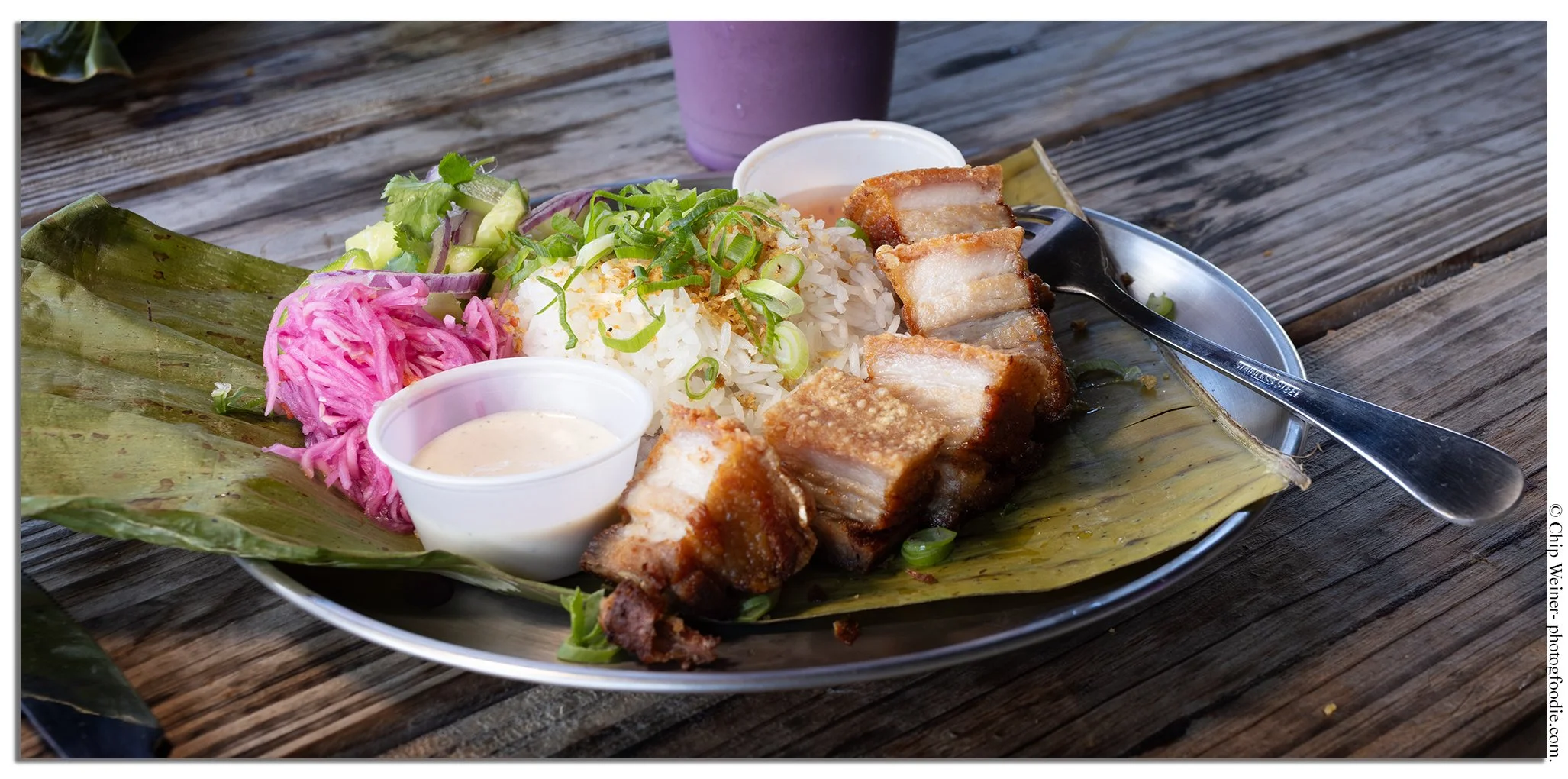 Crispy pork belly plate at Lucky Tigre in West Tampa served with garlic jasmine rice, atchara, and cucumber salad