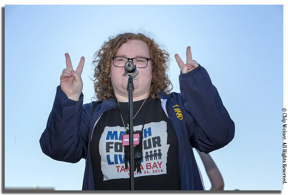Bella Cruz-O'Grady, a senior at Steinbrenner High School, read a poem emphasizing the need for change