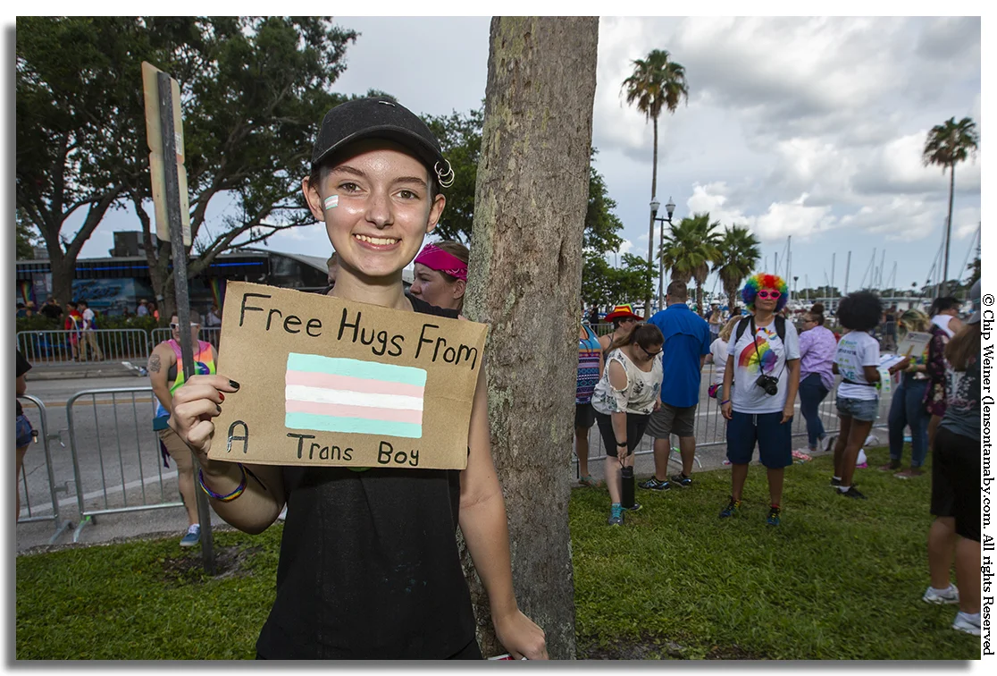This is more emblematic of the spirit of Pride week as I know it. Drew hands out hugs for the asking
