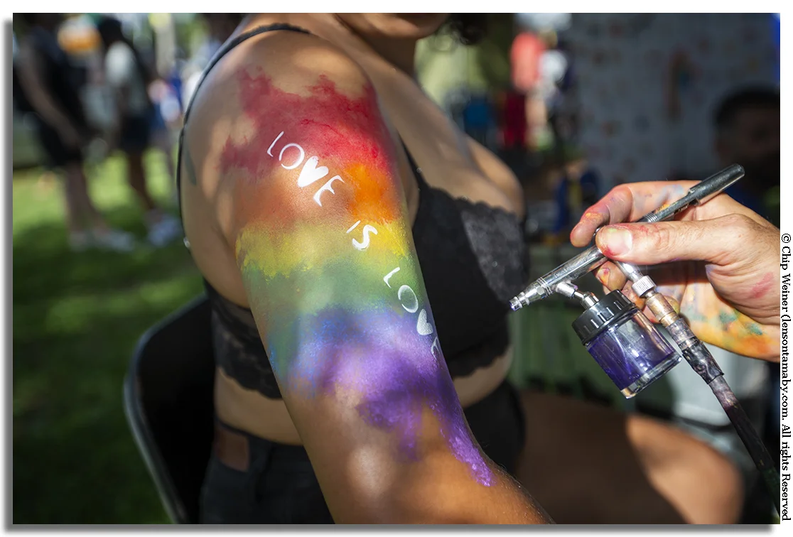 Devin gets a spray tattoo at the Morgan Malice tent with a sentiment heard often repeated at Saturday's gay pride event.