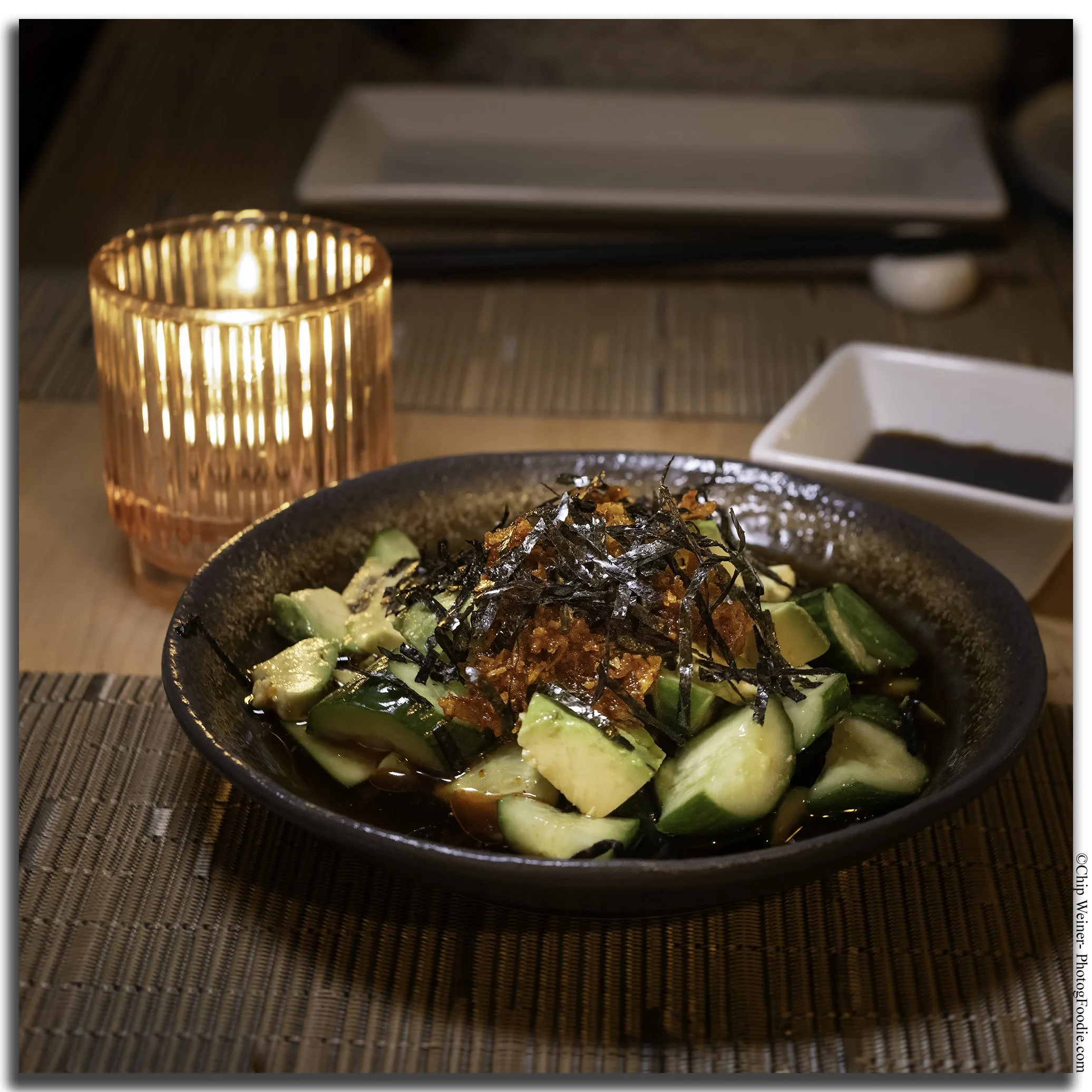 Cucumber and avocado salad at O-Ku Tampa, topped with seaweed and served with ponzu sauce and crunchy chili oil.