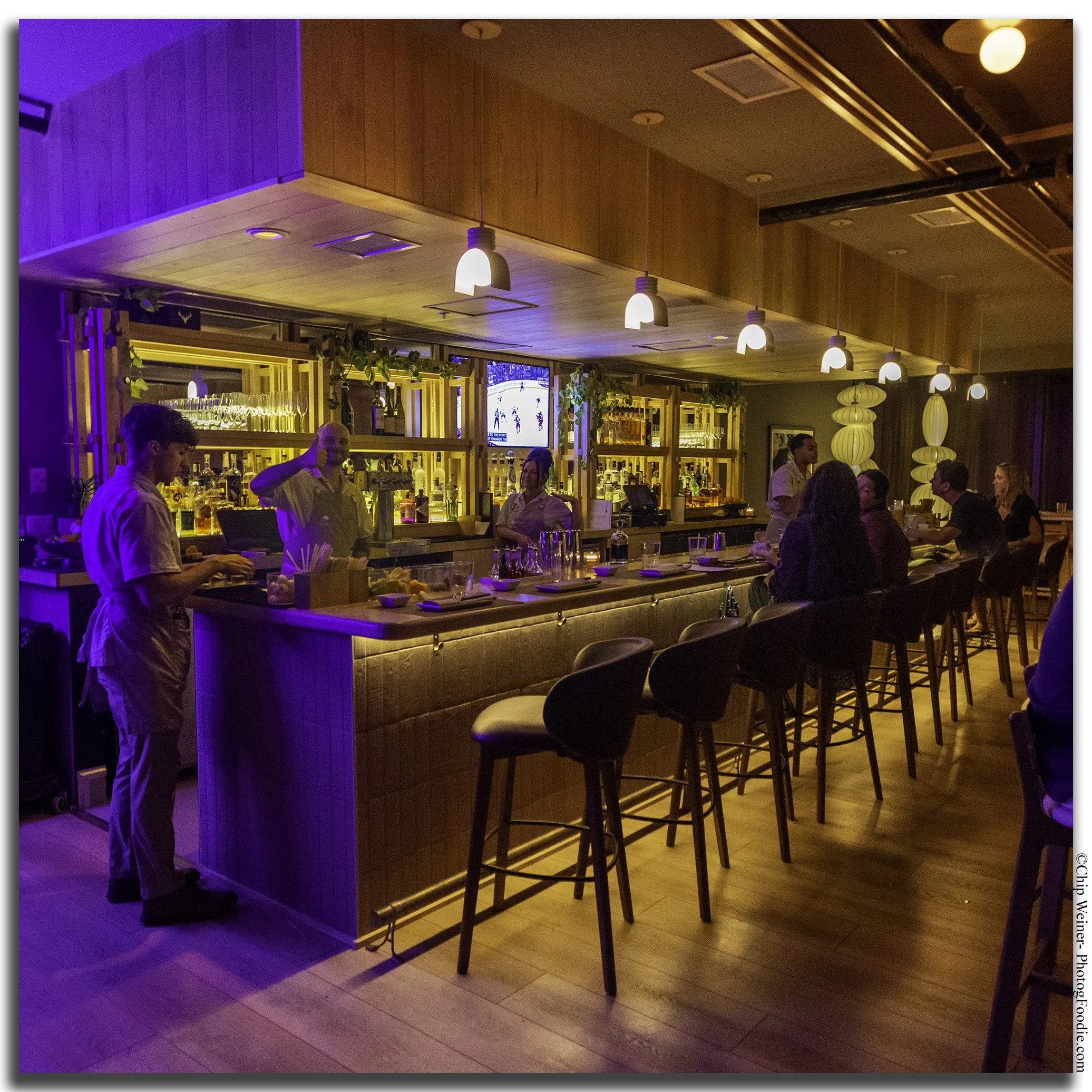 Contemporary cocktail bar at O-Ku Tampa, featuring a stylish setting for cocktails, sake, and Japanese-inspired dining.