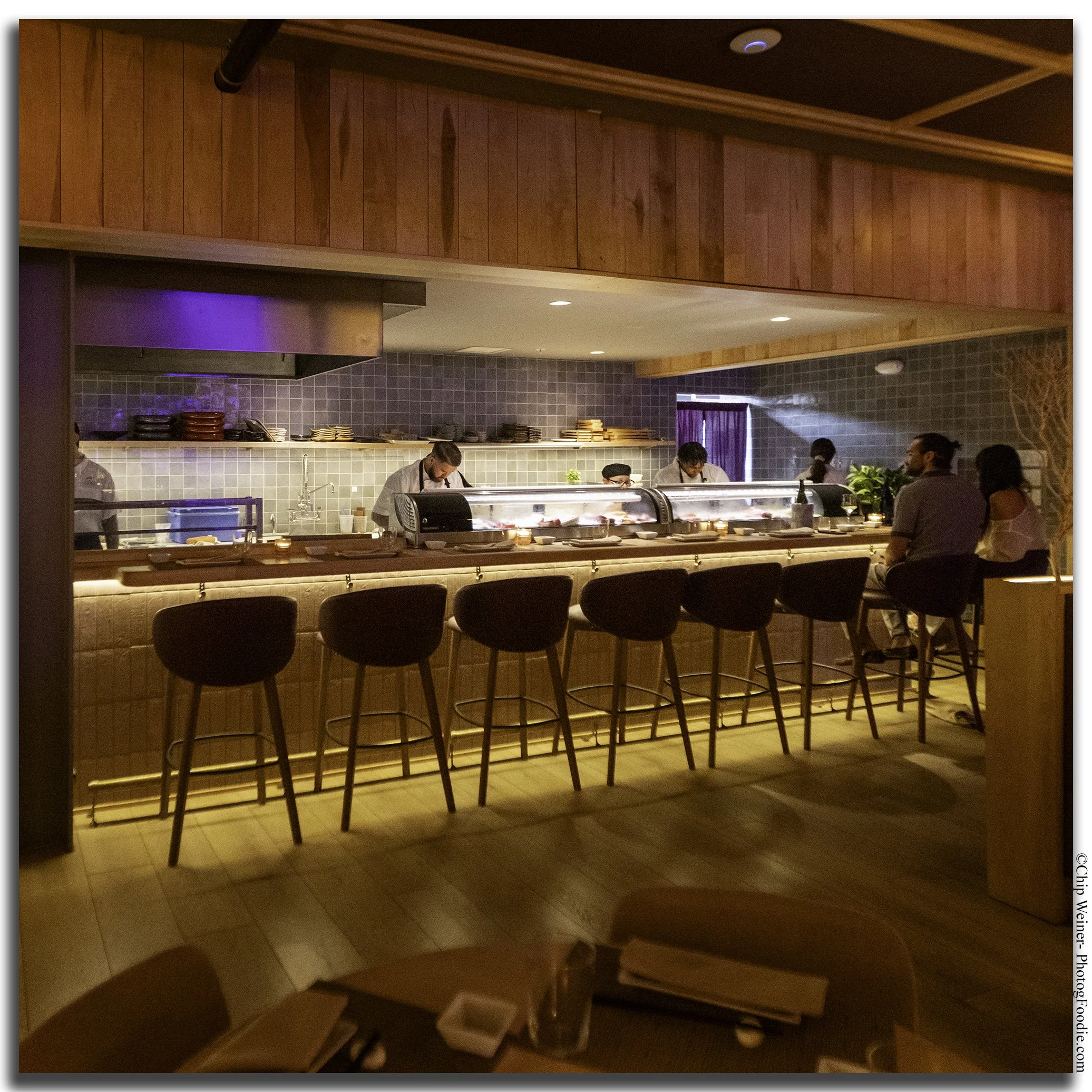 Sushi bar at O-Ku Tampa, a modern Japanese restaurant in the renovated Bayshore Gardens Building, where chefs prepare fresh sushi and sashimi.